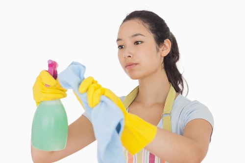 Cleaner following health and safety procedures during a professional cleaning task