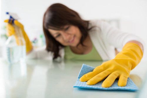 Cleaning a living room in an Edgware rental property before checkout